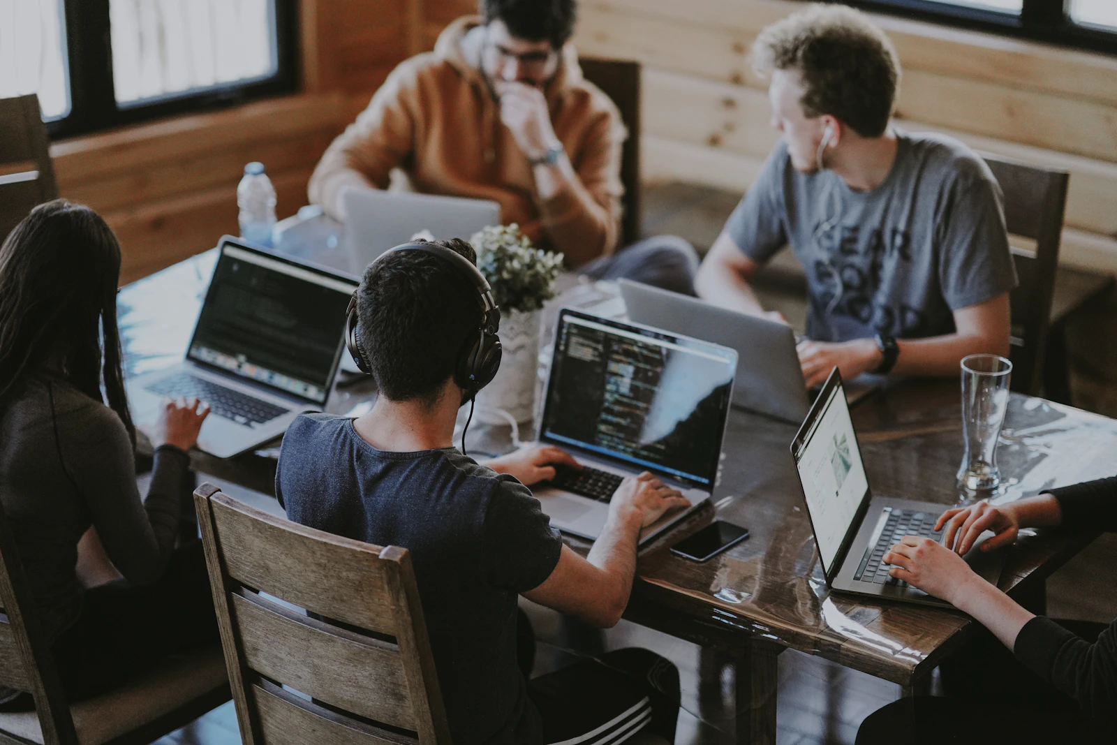 Colleagues gathered around a table in a bright shared workspace
